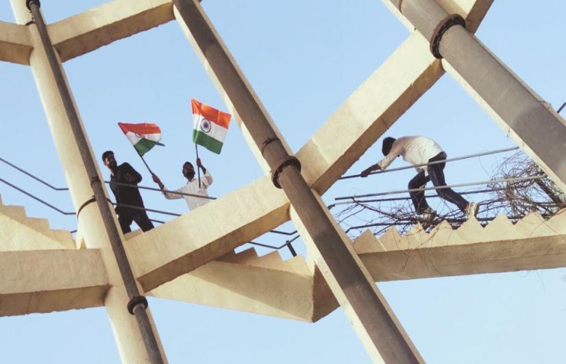 Students climb onto a tank in Hanumangarh town with flags (Photo sourced by Amarpal Singh Verma).
