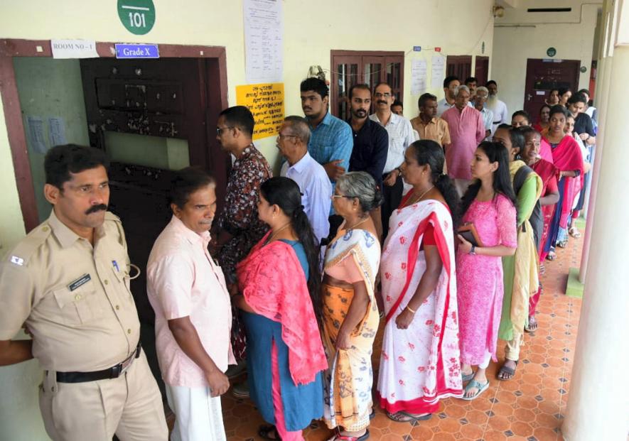 Kottayam: Voters wait in a queue to cast their votes during the by-elections to Puthuppally assembly seat, in Kerala's Kottayam district, Tuesday, Sept. 5, 2023. (PTI Photo)(