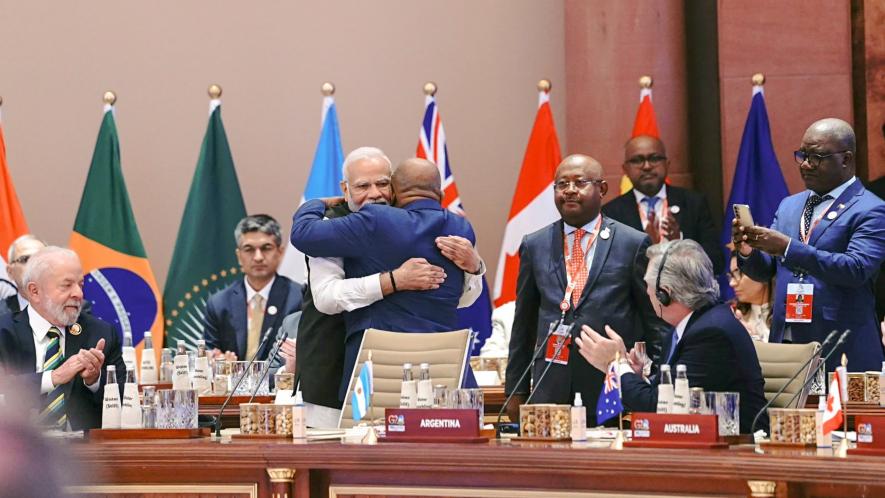  Prime Minister Narendra Modi hugs President of the Union of the Comoros and Chairperson of the African Union (AU) Azali Assoumani as the latter takes his seat after the Union became a permanent member of the G20 during the G20 Summit 2023 at the Bharat Mandapam, in New Delhi, Saturday, Sept. 9, 2023.