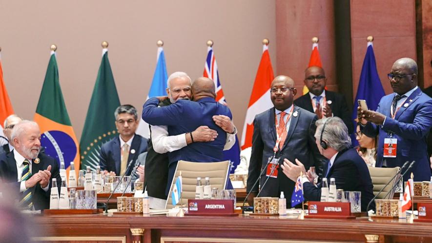 Prime Minister Narendra Modi hugs President of the Union of the Comoros and Chairperson of the African Union (AU) Azali Assoumani as the latter takes his seat after the Union became a permanent member of the G20 during the G20 Summit 2023 at the Bharat Mandapam, in New Delhi, Saturday, Sept. 9, 2023.