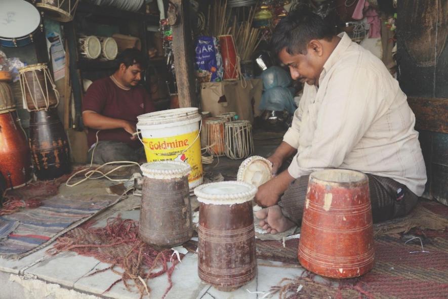 Mohammad Jaffer and Mohammad Bari are absorbed in their daily leather routines.