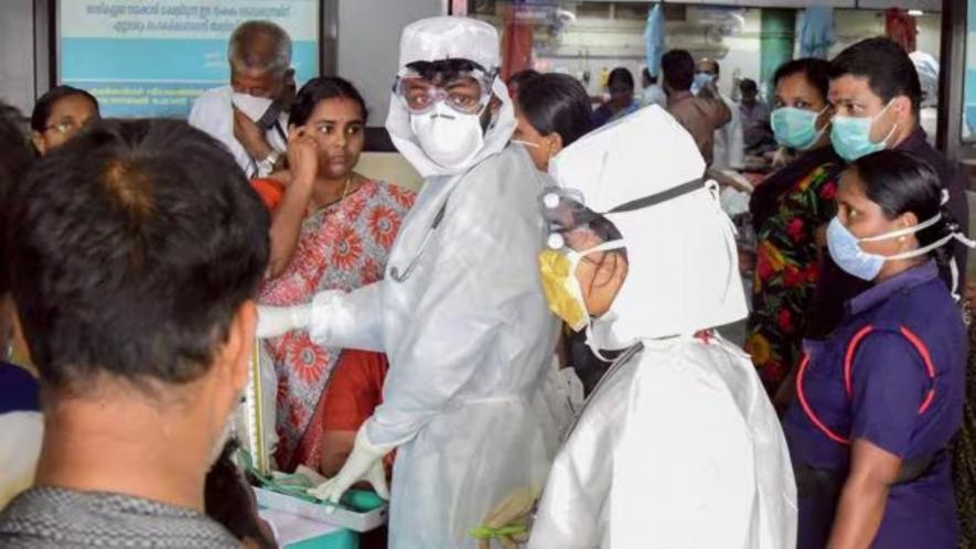 Family members of the patients admitted at the Kozhikode Medical College wear safety masks after the 'Nipah' virus outbreak, in Kozhikode. Image Courtesy: PTI