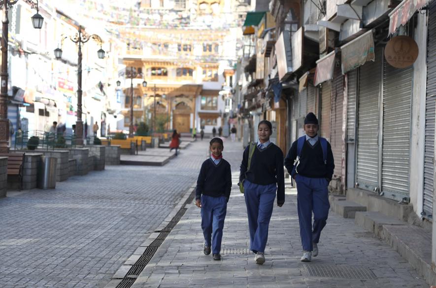 Children seen walking around the Leh Market, going towards their school early in the morning.