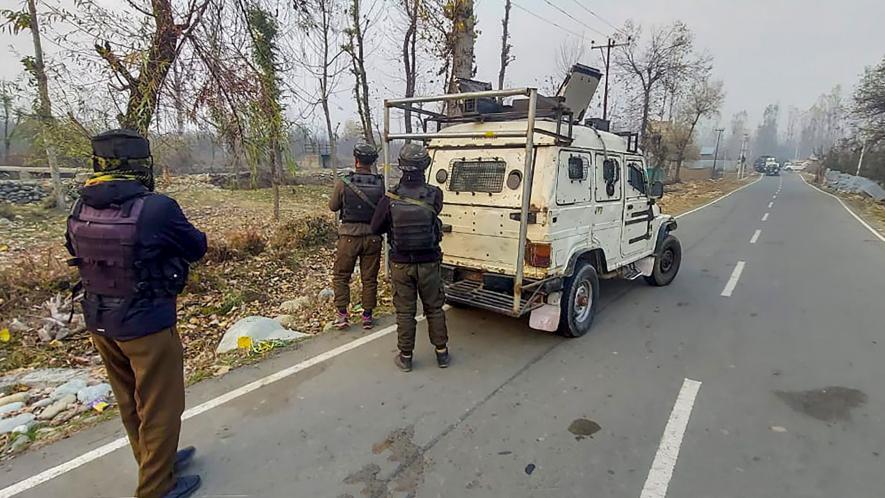 Security personnel stand guard during an encounter with militants, in Kulgam, Thursday, Nov. 16, 2023.
