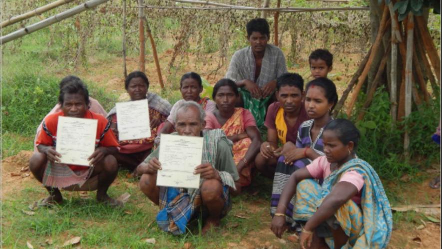 Forestland patta owners of Khemuya village, in West Bengal’s Bankura district, display their documents. The TMC and BJP tried to evict them two years ago.