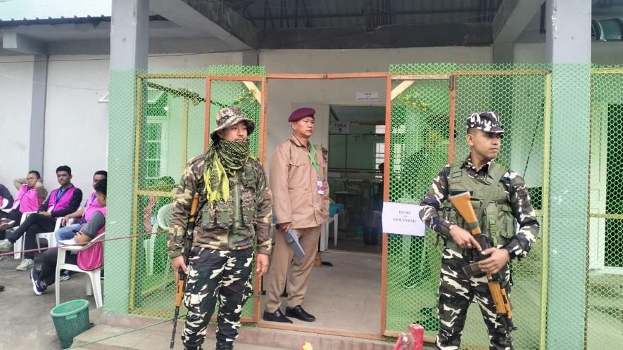 Security personnel stand guard outside a counting centre during counting of votes for the Mizoram Assembly elections, in Serchhip district of Mizoram, Monday, Dec. 4, 2023.