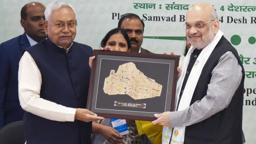 Union Home Minister Amit Shah being presented a memento by Bihar Chief Minister Nitish Kumar during the 26th meeting of Eastern Zonal Council, in Patna, Sunday, Dec. 10, 2023. 