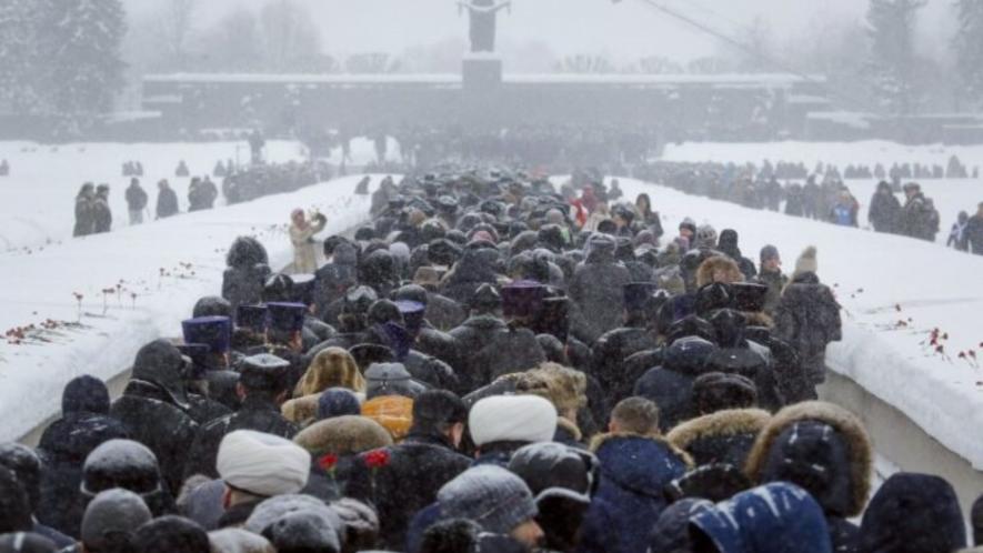 On the 75th anniversary of the battle that lifted the Siege of Leningrad in World War 2, people walk in snowfall to the Motherland monument to place flowers at the Piskaryovskoye Cemetery where the victims were buried, St. Petersburg, Russia, January 26, 2019