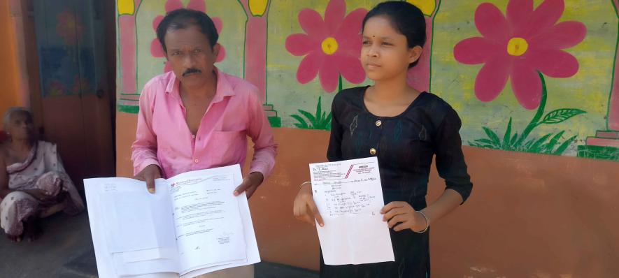 Hansda and his daughter displaying their prescription