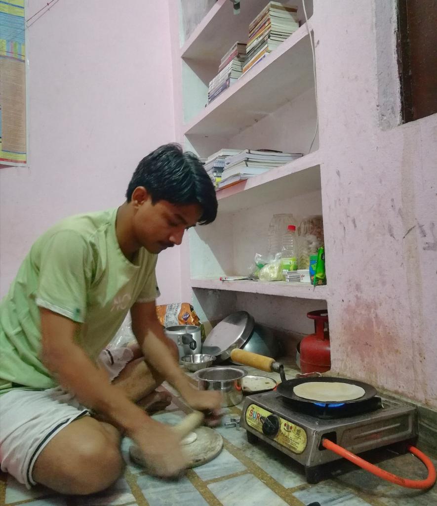 Sandeep Kumar making lunch before going to his coaching.