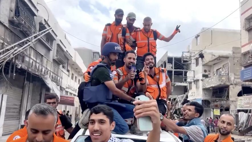 Emergency workers celebrate the announcement of a ceasefire deal. Photo: Screenshot