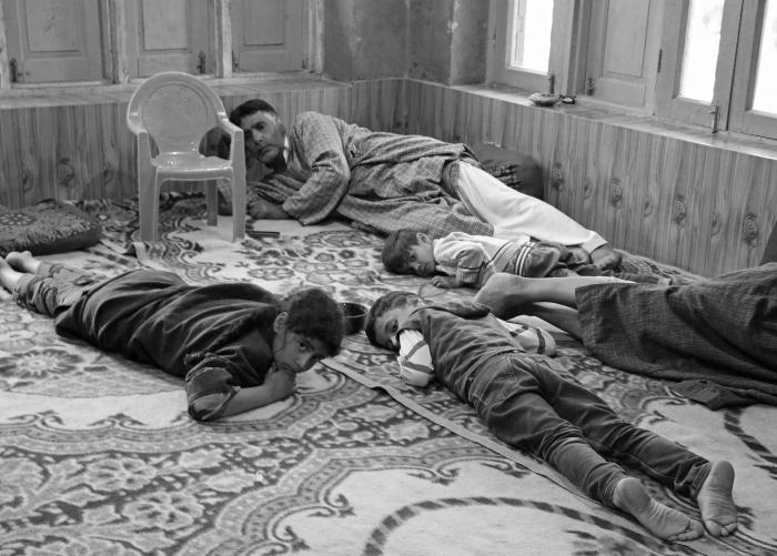 (A family including their three children duck at their home to evade bullets during a gunfight in Beighpora village of Pulwama on May 4, 2020. The encounter ended with the killing of Hizbul Mujahideenâs top commander Riyaz Naikoo and his associate). Picture: Kamran Yousuf/NewsClick