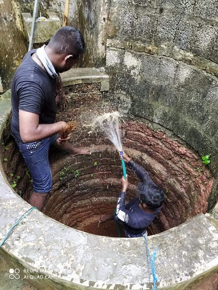 DYFI activists cleaning a well