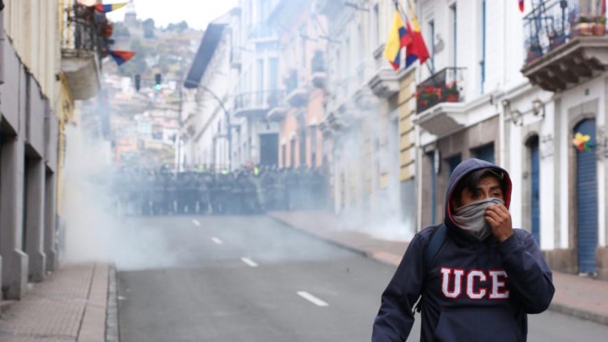 Student runs from police in Quito, Ecuador during mass mobilizations against the neoliberal economic reforms of the Moreno government.